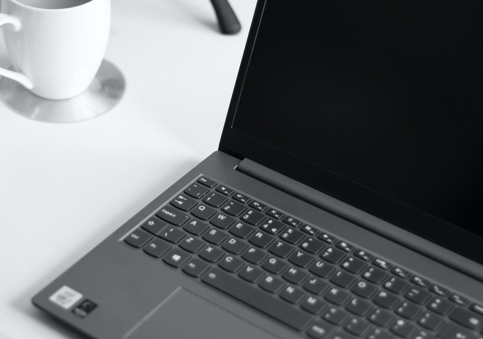 black laptop computer on white table